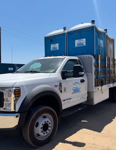 truck delivering porta potties in fresno ca