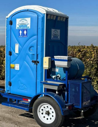 Single towable restroom trailer with an AG Pin hitch and mounted handwash station for mobile use at agricultural operations and remote job sites.