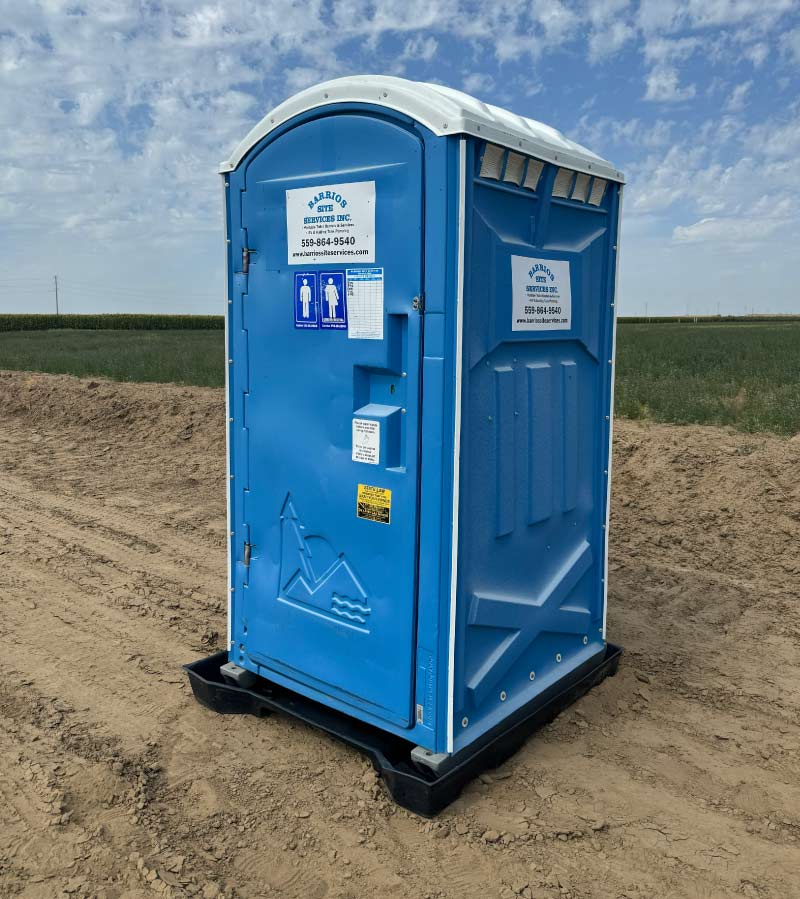 A Barrios Site Services G.A.P. compliant portable toilet for agricultural use, positioned in a Central Valley field to provide farm workers with essential sanitation and external handwashing capabilities.